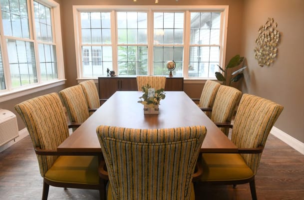 Bright dining room with a large table and six chairs