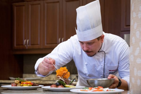 Chef preparing gourmet meal in a kitchen setting