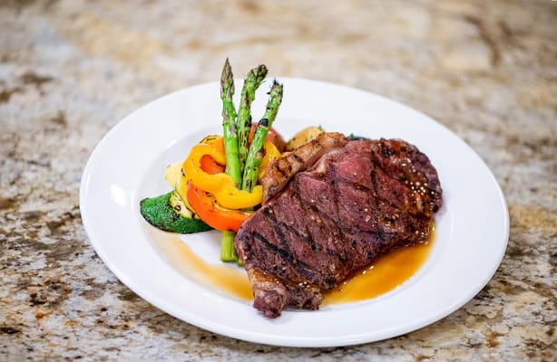 A plated meal of steak and vegetables