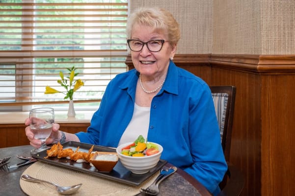 Resident enjoying a meal in the dining area