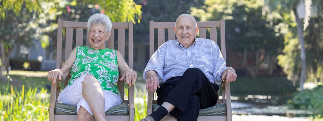 Two residents enjoying a sunny outdoor space