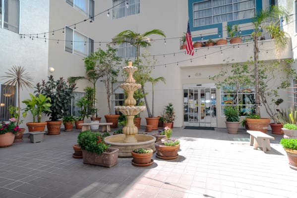 Outdoor courtyard with a fountain and potted plants