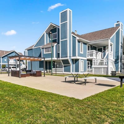 Exterior view of a senior living facility with outdoor seating