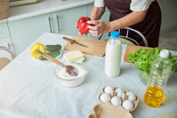 A caretaker preparing food in a kitchen setting