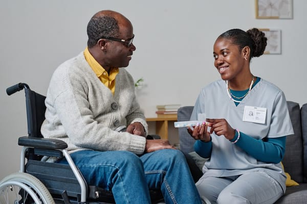 A caregiver with a resident discussing medication