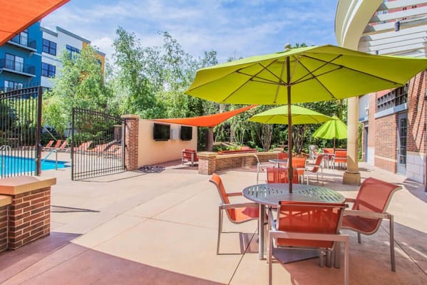 Outdoor patio area with colorful umbrellas and seating