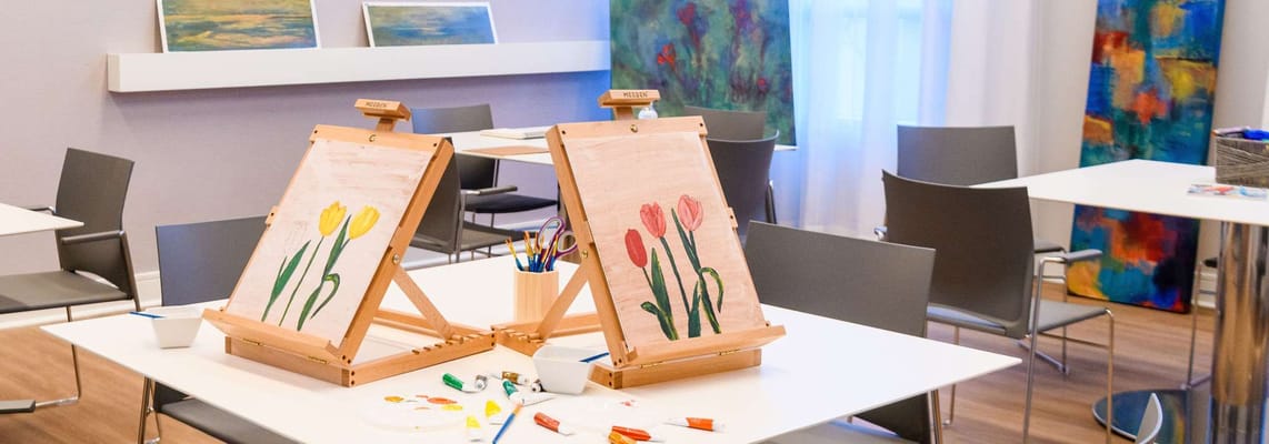 Art supplies and easels set up in a colorful activity room