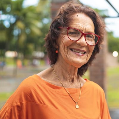 Senior woman smiling in a garden setting