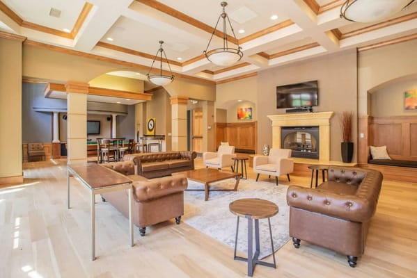 Bright common area with seating and a fireplace