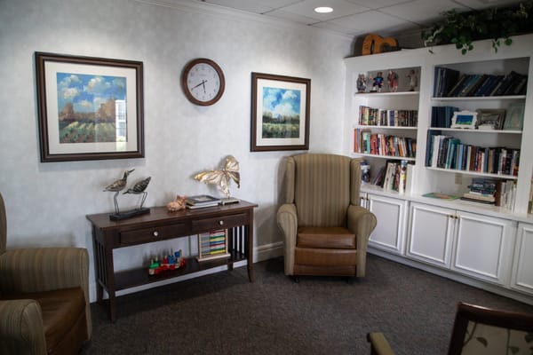 A cozy common area with bookshelves and seating