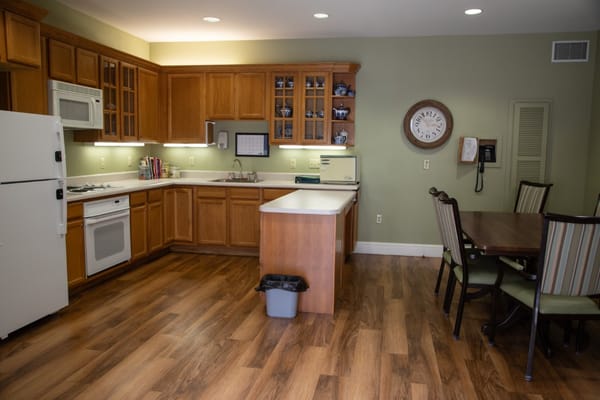 Bright, open kitchen area with wooden cabinets and dining table