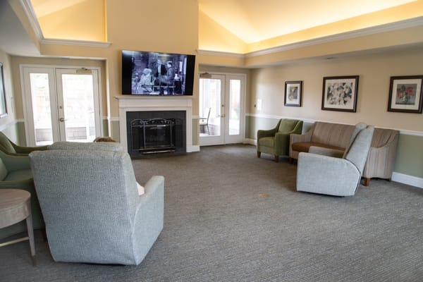 A cozy common area with seating and a fireplace
