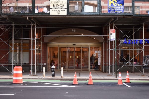 Front entrance of a senior living facility with scaffolding