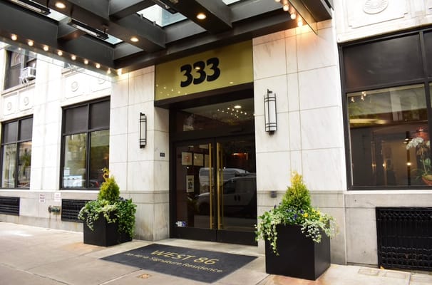 Main entrance of Atria West 86 with planters.