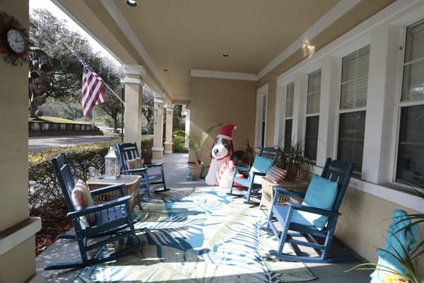 Outdoor seating area with rocking chairs and decorations