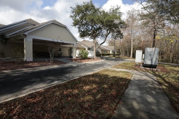 Outdoor view of a senior living community with walking paths and greenery