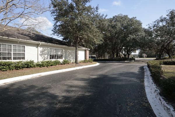 Pathway lined with trees near the facility