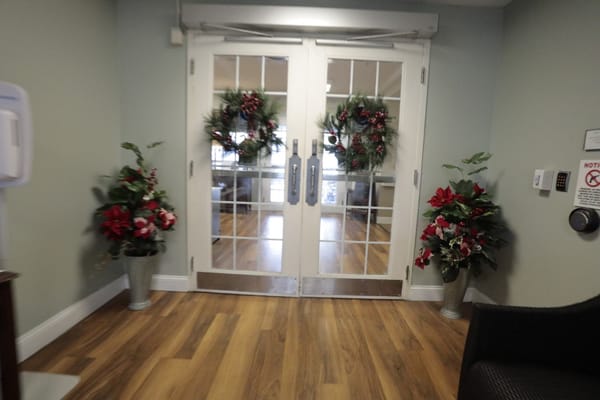 Decorated entrance with festive wreaths and flowers