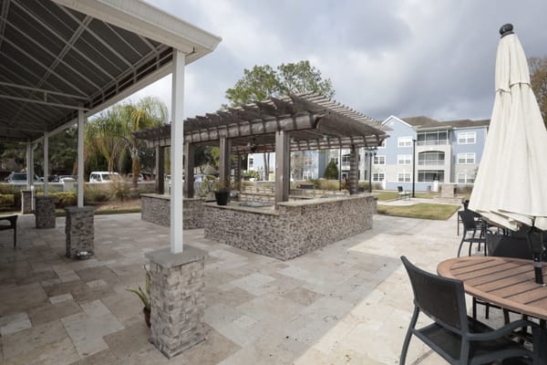 Outdoor seating area with pergola and gardens