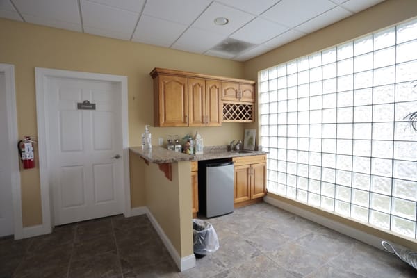 Bright interior kitchenette with wooden cabinetry
