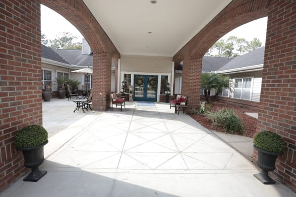 Covered entryway with seating and landscaping