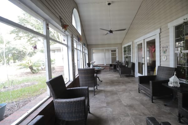 A relaxing sunroom with seating and outdoor view