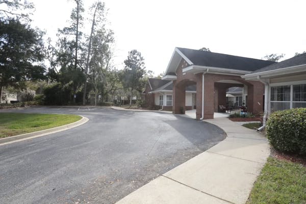 The exterior of a senior living facility with landscaped grounds