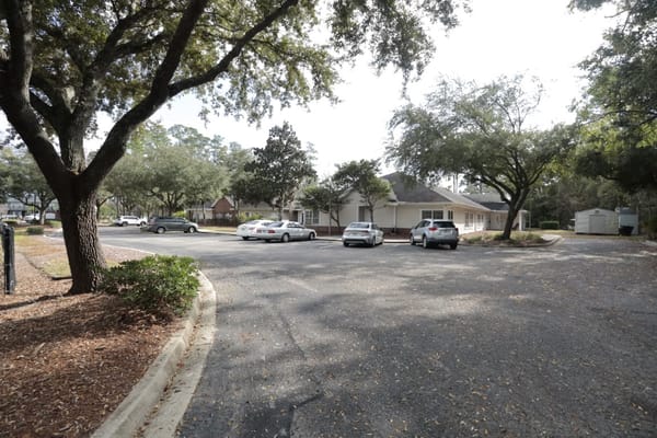 Parking area with facility building in the background