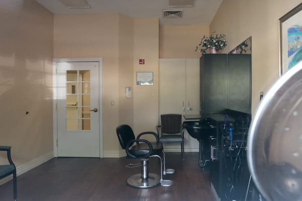 Interior view of a salon with styling chair and sink