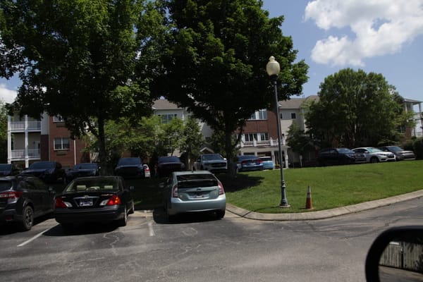 Exterior view of the facility with vehicles and landscaping