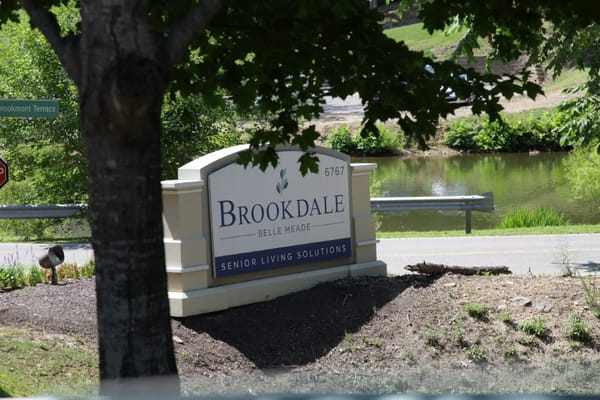 Facility sign in a green outdoor setting