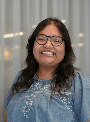 Staff member smiling in a brightly lit common area