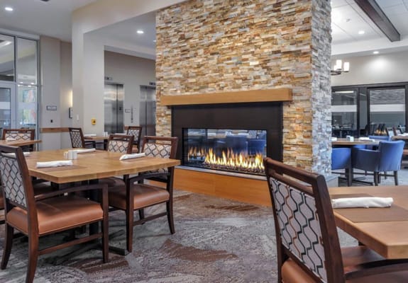 Dining room with a fireplace and seating