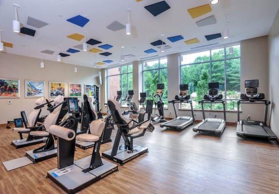Interior fitness room with exercise equipment and natural light