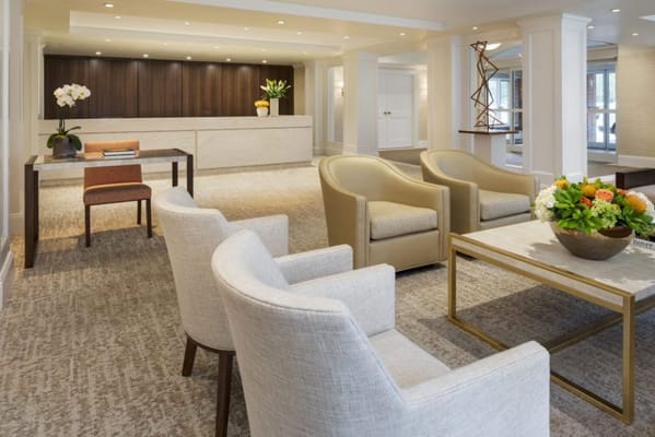 Bright, inviting lobby area with seating and flower arrangements