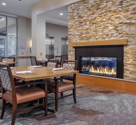 Bright dining area with a fireplace centerpiece