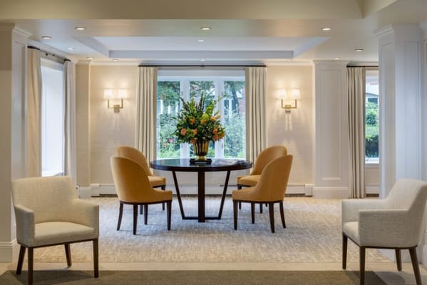 Bright common area with seating and a floral arrangement