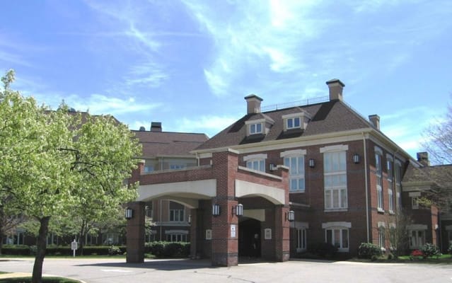 Exterior view of a senior living facility with gardens