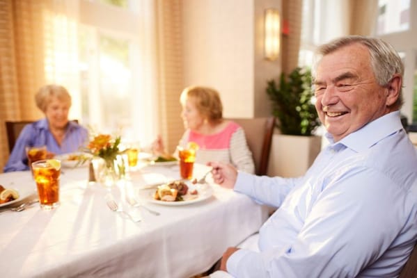 Seniors enjoying a meal in the dining room