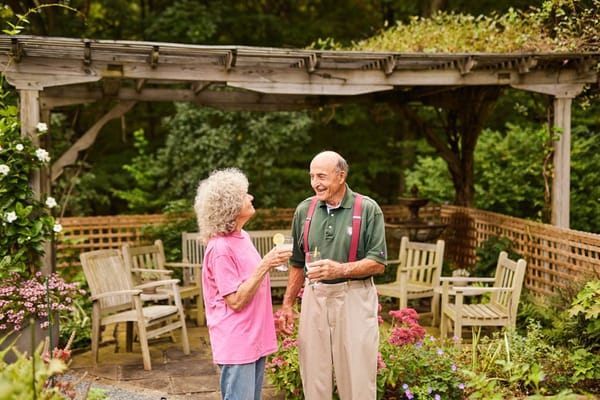 Residents enjoying a garden space with drinks