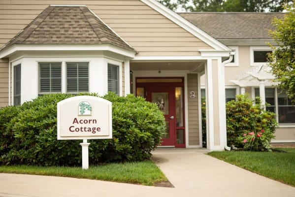 Exterior view of Acorn Cottage with signage