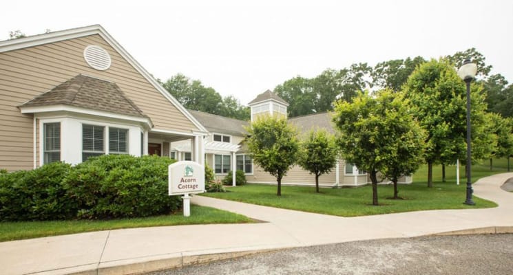 Exterior view of Acorn Cottage with landscaped grounds