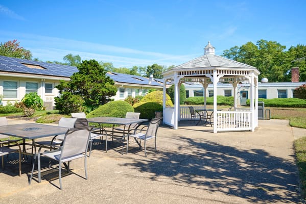 Outdoor gazebo with seating in a garden area