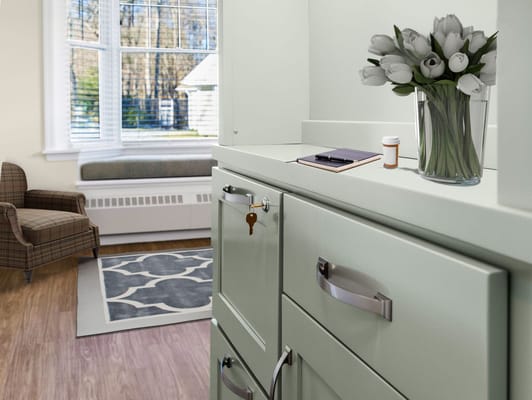 Interior photo of a resident's room with floral arrangement