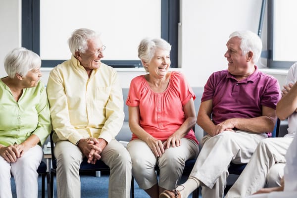 Seniors laughing and enjoying conversation in a group setting
