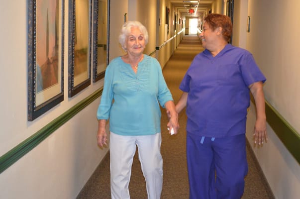 Staff member assisting a resident in the hallway