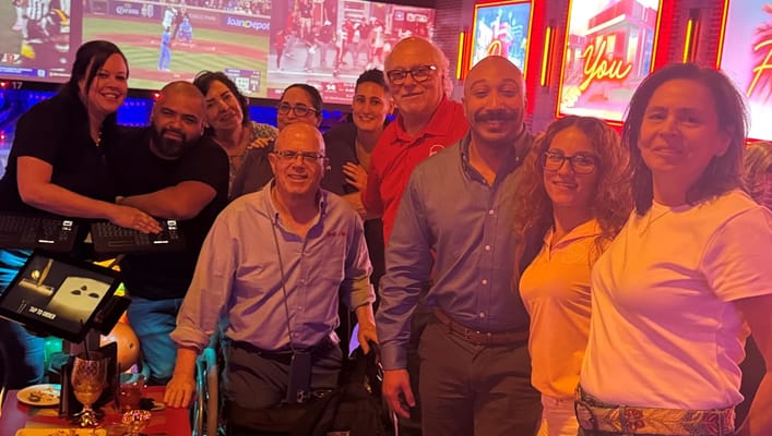 Residents and staff posing joyfully in a common area