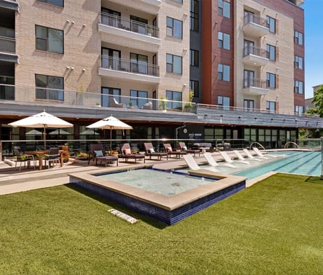 Outdoor pool area with lounge chairs and umbrellas