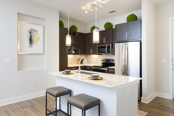 Modern kitchen interior with island seating and appliances
