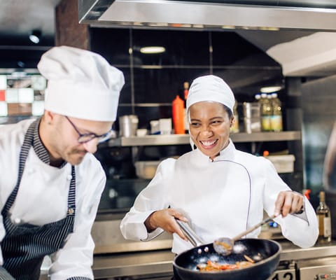 Chefs preparing food in a modern kitchen